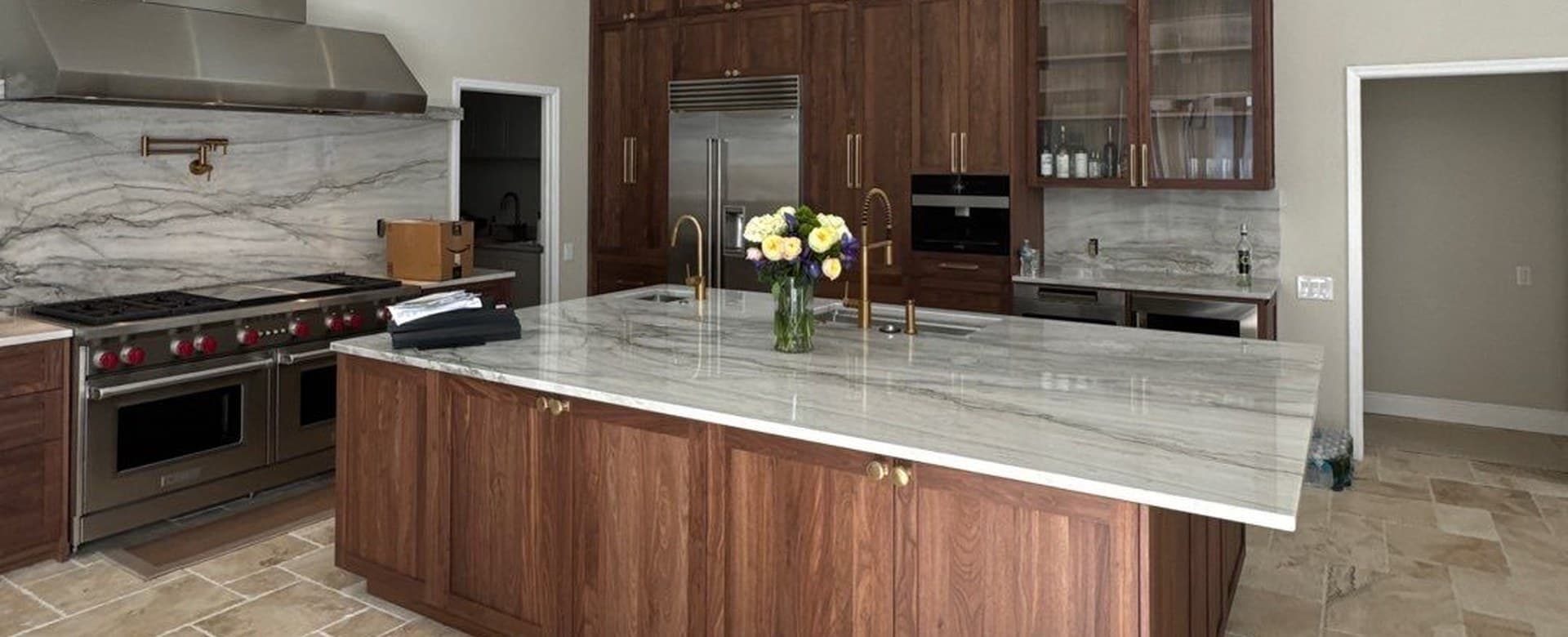 Walnut kitchen island with a white stone top in a Tampa kitchen remodel