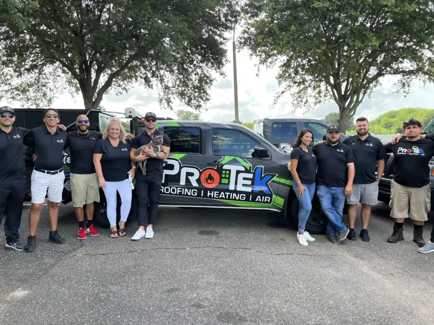 Protek remodeling team standing beside a company work truck in Tampa FL