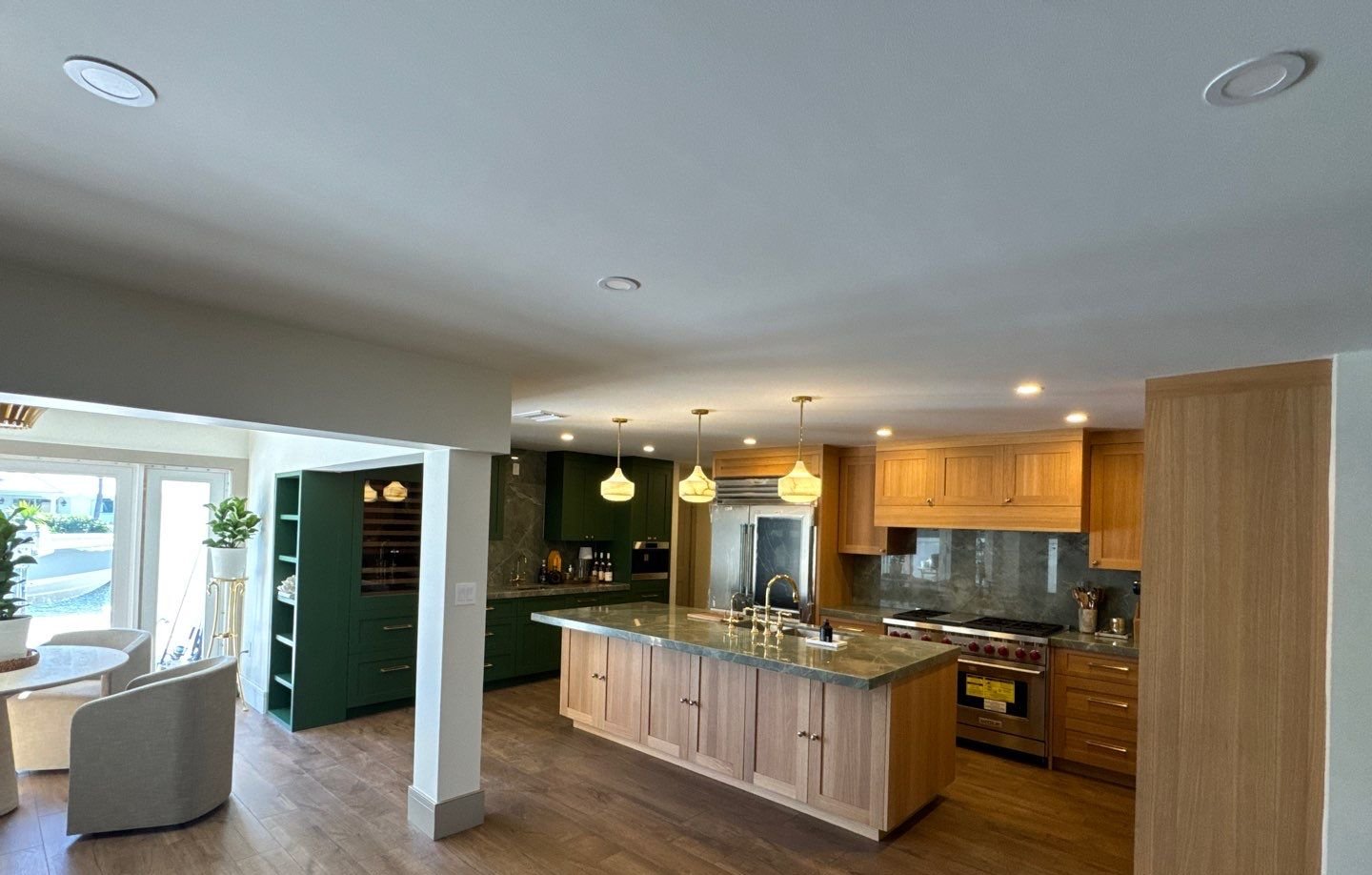 Custom kitchen remodel in Saint Petersburg FL with rift white oak island and green shaker cabinets