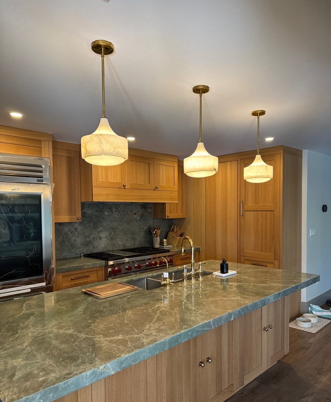 Quartzite countertop detail with full-height backsplash and professional range