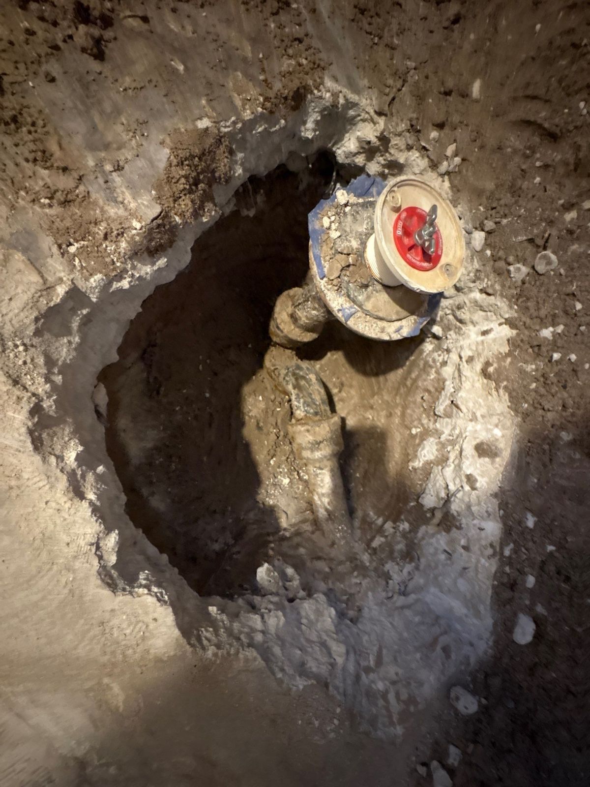 Slab opened to relocate a toilet drain during a bathroom remodel