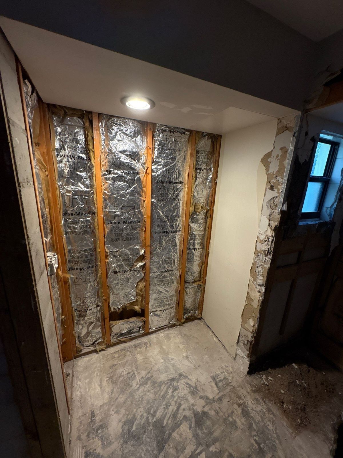 Old shower demolished to the studs during a Tampa master bathroom remodel